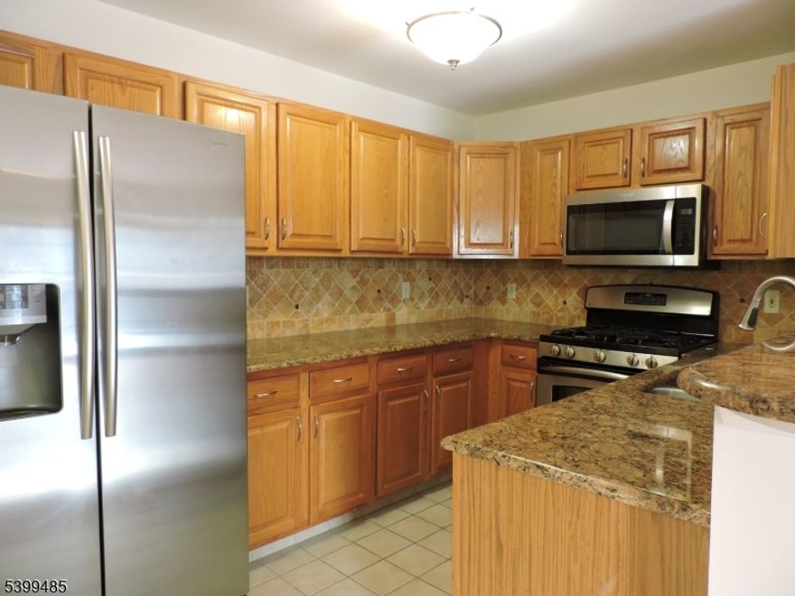 Updated two-bedroom in the heart of Downtown Morristown. This multi-floor unit offers an open floor plan with a kitchen featuring granite counters and a breakfast bar, flowing into a large living room with a gas fireplace and sliders to a private deck. The first floor also includes a laundry closet and a powder room. Upstairs, you'll find two spacious bedrooms and a full bathroom. Additional perks include a storage room in the garage plus an extra parking spot in the driveway. Fantastic central location just steps to restaurants, shops, and the train!