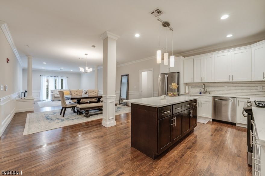 MOVE-IN READY 2 BED/2 BATH BRANCHBURG CONDO CLOSE TO EVERYTHING! Just off 202 & under 5 miles from Bridgewater Commons Mall, heart of historic Somerville w/ NYC train & minutes from all the shops & services you'd ever need, this pristine first floor condo is in a quiet, modern building w/ underground garage parking. Enjoy security code access to large lobby & before stepping into a bright open floor plan w/ beautiful hardwood floors, crisp white wainscoting w/ pillars & soaring ceilings. The heart of this unit is the modern Kitchen, Dining & Living areas that blend seamlessly to provide the perfect ambiance for leisure & comfort. Updated Kitchen shines with white cabinetry, quartz countertops, large island with nicely contrasted black base & SS appliances including gas range w/ griddle, dishwasher, microwave & French door/bottom freezer fridge. Dining area w/ chandelier leads into Living Room with plenty of room for seating & access to private balcony through sliding French doors. Working from home is a breeze with dedicated office/den off of the Kitchen. Relish the in-unit Laundry Room w/ extra storage closet. Hallway Full Bath has tub/shower combo & quartz vanity & leads into large Bedroom with double windows. Opposite side offers gorgeous private Primary Suite w/ huge storage closet & Full Bath w/ double quartz vanity & tiled walk-in shower, Walk-in Closet & serene Bedroom. Additional hallway storage unit available on the same level. Plus only a mile to Duke Island Park!