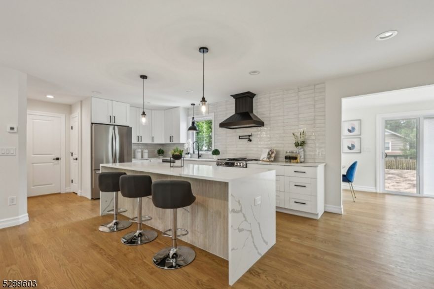 FULLY RENOVATED COMMUTERS DREAM HOME! Steps away from Allendale downtown and direct train to NYC! This beautiful property combines modern luxury with classic charm, offering an exceptional living experience. With modern fixtures, elegant hardwood flooring, and tasteful design elements throughout, this dream home create a warm and inviting atmosphere.The chef's kitchen boasts a 10 ft center island, breakfast bar, and top-of-the-line appliances. The open layout seamlessly connects the kitchen and living room, creating a perfect space for entertaining and daily living.The dining room is sun drenched with oversized windows looking at the HUGE backyard. The first-floor master suite allows for generational living, featuring a spacious walk-in closet and a luxurious ensuite bathroom. While the second floor offers two oversized bedrooms and a full bath, perfect for guests or a home office. In addition to the large basement recreation area, the walk-out basement includes an additional egress bedroom with its own full bathroom, ideal for guests or as an in-law suite. Situated in a peaceful neighborhood, this home offers easy access to excellent schools, shopping, dining, and is close to nearby Crestwood Lake & Park and Celery Farm. Looks are deceiving in this oversized cape! MUST SEE! Don't miss the opportunity to call this exceptional home yours!