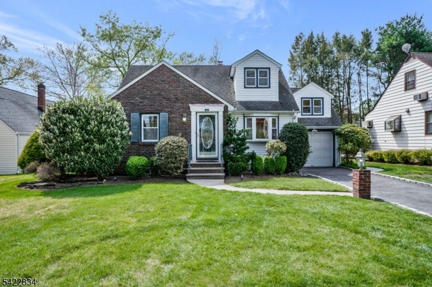 Nestled in one of Cranford's most sought-after neighborhoods, this beautifully expanded Cape Cod offers the perfect blend of charm, space, and modern updates. Set in a prime location, this three-bedroom, two full bath home with a one-car garage welcomes you with exceptional curb appeal, highlighted by a blacktop driveway lined with Belgium block and ample parking.Step inside to discover gleaming hardwood floors and an expansive living room featuring crown molding, elegant up-lighting, and classic archways that add warmth and character. The thoughtfully expanded kitchen and sitting area serve as the heart of the home, showcasing granite countertops, custom cabinetry, a counter bar, and five convenient lazy Susans. Walls of windows flood the space with natural light and provide seamless access to the private backyard patio perfect for relaxing or entertaining. The dining room is equally impressive, complete with custom built-ins and a stunning bay window that enhances the bright, inviting atmosphere. A first-floor bedroom with charming beamed ceilings sits adjacent to a full bath with a jetted tub, offering flexibility for guests or primary-level living. Upstairs, you'll find two additional bedrooms, a full bath with a stall shower, and a versatile step-down den or home office off one of the bedrooms. The lower level includes a recreation area along with a second washer and dryer setup. Additional highlights include multiple heating zones and a full-gasline generator.