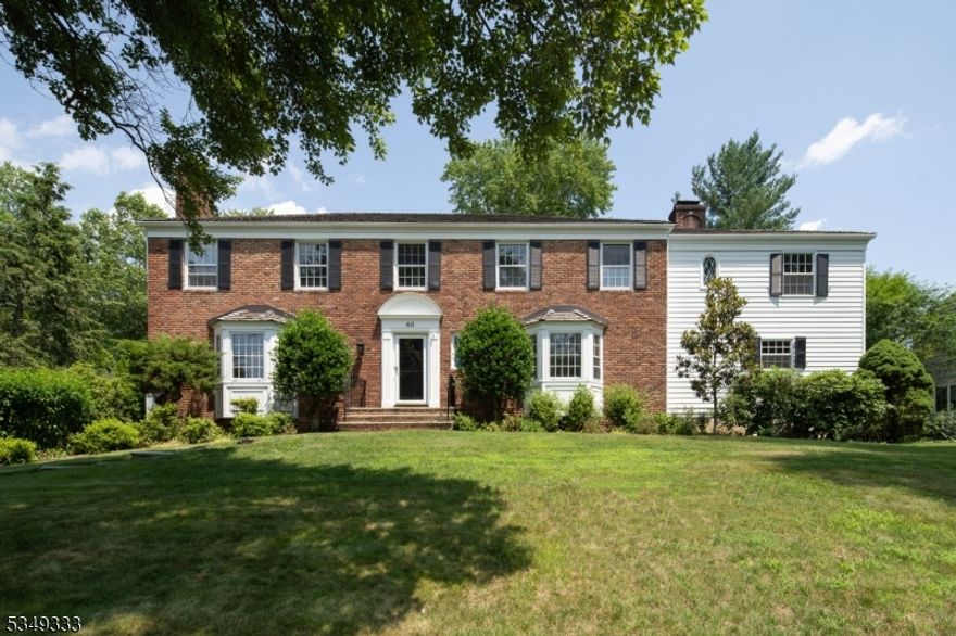 Perfectly set on a quiet street in the coveted Wickham Woods neighborhood, this spacious 5 bedroom, 3.3 bath home offers space, warmth, and an effortless open floor plan. Set on .45 acres of lush, fenced-in grounds with a sparkling pool and expansive deck, this home truly is your own private retreat. Designed for both grand entertaining and everyday comfort, at the heart of the home is the expansive kitchen truly a dream with its oversized island, updated appliances, generous pantry, and cozy two-sided fireplace shared with the sun drenched family room.  The kitchen flows seamlessly into the spacious breakfast room and spectacular family room featuring a wall of windows, a stone fireplace, stylish wet bar, and plenty of space to gather or unwind with french doors opening to the backyard. A first floor den with fireplace, living room, and dining room completes this first level. Upstairs 5 bedrooms, including a primary suite tucked away for privacy, enjoys a walk-in closet and spa-like ensuite bath and balcony overlooking the pool and yard. An additional bedroom features an ensuite bath, while the remaining share a spacious hall bath. A convenient back staircase enhances the home's thoughtful layout.The finished basement offers abundant space for recreation, fitness, or play, with a large recreation room, 2 storage rooms, and wine cellar. A rare opportunity to live in one of Chatham's most sought-after neighborhoods, just minutes from town, top rated schools, and train.