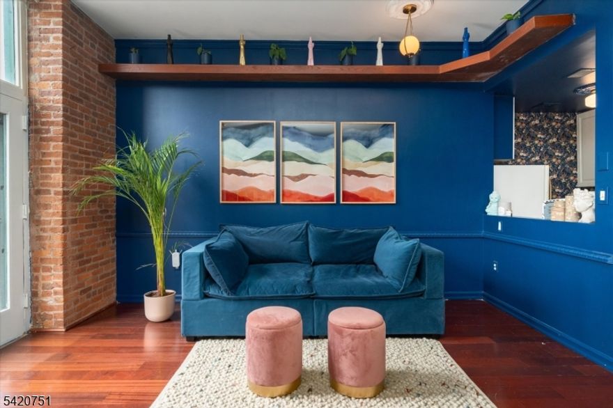 Here's your opportunity to own a magical and bespoke studio at The Mill - one of only three units with a 500sq ft patio! The outdoor space is complemented by a beautiful studio, painted in the very au courant color-drenched shade of "Symphony Blue", seamlessly bringing the outdoors in. This studio has central heat and air, its own washer/dryer, along with a separate kitchen with dishwasher and plenty of cabinet space that allows you a beautiful view of the patio. Exposed brick bridges the living and sleeping areas, along with possibilities for both a WFH and dining space. There's plenty of storage, too - the high ceilings allow for three tall storage closets and a clothing closet. This pet-friendly unit comes with one assigned parking space and an easy commute - it's one block to a NYC-bound train, and 5 minutes to a Park and Ride. Take advantage of all that The Mill has to offer, gym, pool, tennis/pickleball court, and much more!