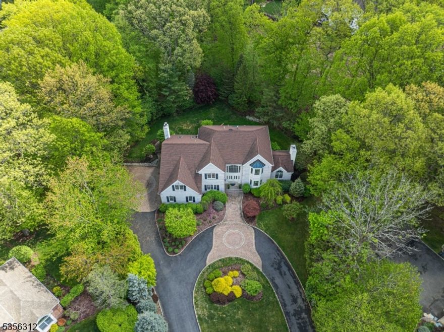 Nestled in one of Morris County's most desirable towns, this stunning Colonial offers an upscale lifestyle on a quiet cul de sac amid an enclave of luxury homes.. Stunning, custom colonial on nearly an acre. A striking 2-story foyer announces the home's modern elegance. The entry is flanked by a spacious dining/living room & office. The hub of the home is the family room w/cathedral ceilings & a gas burning fireplace which opens to the large kitchen with oversized center island. The library or study showcase fine craftsmanship & mill work. Great space & floorplan for entertaining guests. The curved front staircase is 1 of 2 that lead to the 2nd level. Upstairs you'll find an indulgent primary suite with a sitting area, walk in closet & large bath. An additional 3 bdrms & bath complete this floor along with a large bonus room which works as an office or playroom. Tons of storage in 3 car garage or full, finished basement with another 2 staircases from 1st level or directly from the garage for convenience & accessibility. Large windows throughout provide a beautiful ambience, tons of natural light. Perfectly situated at the end of the cul de sac with a gorgeous circular paver driveway. TONS of curb appeal! The backyard is completely fenced in with a large deck. In- ground sprinkler system. Great location, just mins from Union Hills Shopping Center, Denville's bustling DWTN, Morristown Green, NYC-Direct transport & easy access to major hwys. Great schools!