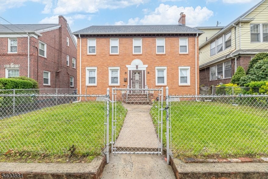 Beautifully maintained all-brick Colonial in the Upper Clinton Hill section of Newark. This spacious home offers 4 bedrooms, 2.5 baths, hardwood floors throughout, an updated kitchen and baths, a bright formal dining room, and an oversized living room with fireplace. Finished basement adds usable space. Private driveway, 2-car garage, and fenced yard complete the exterior. Convenient to schools, parks, shopping, and transportation. A rare opportunity to own a classic, move-in-ready home on a quiet residential block.