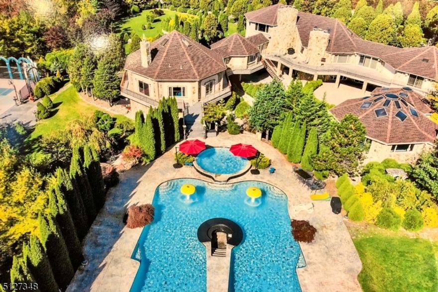 Unique home offering 7 bedrooms, 7 baths, indoor & outdoor heated pools, hibachi table, exercise room, walk-in sauna for 8-10 people downstairs and private 2 people sauna in owner's bath. A custom circular-room movie theater on the second level. Sunken fireplace areas throughout the home and built-in bar for entertainment. Water wall in the lower level, wet bar and access to the outdoor fountain garden which leads you to the outdoor heated pool, tennis and horshoe-pit game areas.