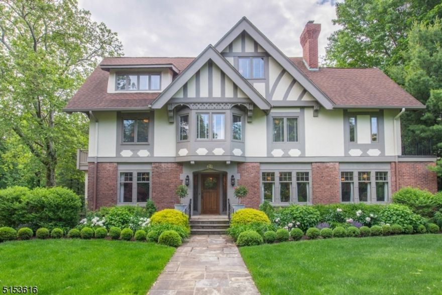 Welcome to this sophisticated, elegant,  7 bedroom 4.1 bath,  A.F. Norris style Tudor in historical Erwin Park area.  The interior is professionally designed and includes a grand entrance foyer (with fireplace) between the library and dual living rooms (with dual marble fireplace).  Well suited for entertaining, the living rooms lead to a  family room and formal dining room, both with French doors to a wrap around deck, overlooking the expansive property, gardens, gas firepit and patio. The kitchen boasts a  Wolf cooktop, Subzero refrigerator, Miele built in coffee system and a wine refrigerator. Granite counters with a marble island and separate dining area which also has deck access.  Luxuriate in the second level primary suite with fireplace, Calcutta marble bath with jetted tub and shower, adjoining the office/sitting room with access to a private veranda.  Three bedrooms, one with a Juliet balcony and marble bath complete this level.  Third level is comprised of three bedrooms, marble bath and attic storage.   Ground level has rec room, full bath and garage access.  Architectural details include beamed ceiling, panel wainscotting, red oak floors, deep moldings and diamond paneled leaded glass windows.  Amenities include two units of central air, two heating furnaces (with three zones) ,sound systems, security system,  four car heated garage, professionally landscaped property.  Convenient to NYC transportation, shopping, dining and all that Montclair has to offer.