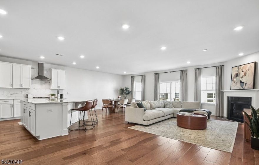 Welcome to the Monterey, a beautifully appointed 2025 new construction townhome with thoughtful owner upgrades throughout, and truly move-in ready from day one. The main floor sets the tone with 9-foot ceilings and an open-concept layout that flows seamlessly from a chef's kitchen, featuring quartz countertops, a substantial center island, and stainless-steel appliances, through the dining area and into a light-filled living room anchored by a gas fireplace. Upstairs, three bedrooms and two full bathrooms await, including a primary suite designed for refined everyday living. Two professionally installed walk-in closets with full organizers, a double-vanity bath, and a sitting room adorned with custom wallpaper create an elegant space. A versatile loft and a laundry room with custom cabinetry and countertop complete the upper level with effortless comfort and convenience. The fully finished lower level extends the home beautifully, offering a full bathroom and generous space for a home gym, entertainment room, and more. Added peace of mind comes with a 2025 whole-house water softener, a kitchen water purifier, and nine years remaining on the NJ new construction warranty. The community clubhouse is just steps away, featuring a lounge, indoor fitness center, and outdoor pool. Ideally situated close to shopping, dining, major highways, and transit to New York City.