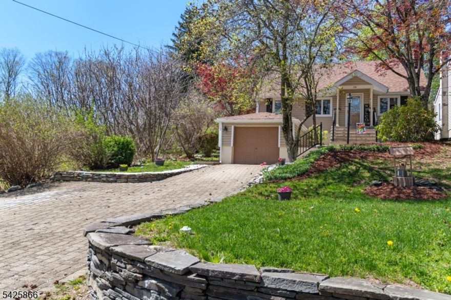 Welcome to this beautifully updated home in lower West Milford, with nothing to do but move in!  This three bedroom custom cape features a newer kitchen & bath, hardwood flooring, fenced in manicured yard, 1 car garage, wood burning fireplace, & high ceilings in the living room.  From the cobble stone driveway, to the newer front walkway & stairs, you'll find this home has been updated throughout.  The roof & gutters were done in 2024, siding in 2025, & a newer well pump also.  Enjoy the patio & trex deck in the fenced rear yard, perfect for entertaining.  Located near the middle & high school, in addition to Bubbling Springs, a 40 acre recreational site with a swimming lake, ball fields, gazebo, hiking trails, & fishing.  Come see this home for yourself!