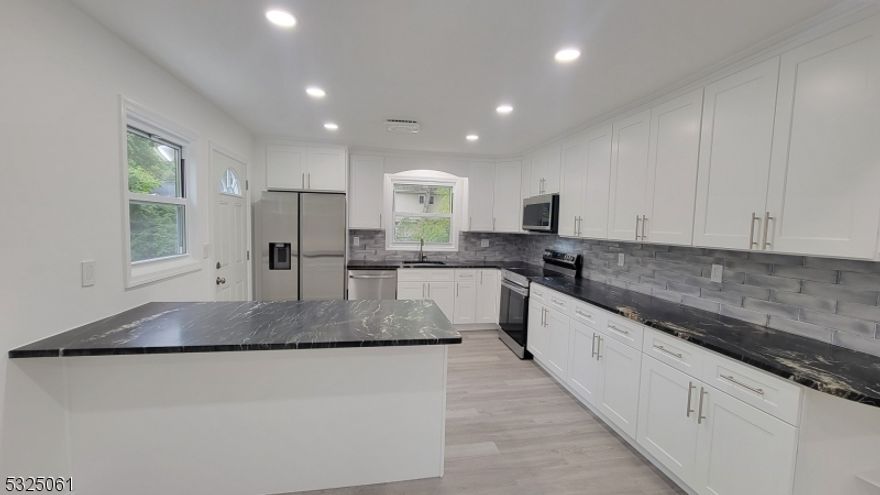 EXPECT TO BE IMPRESSED!!  One floor apartment on the main floor in a two family home featuring BRAND NEW beautiful kitchen with white cabinets, granite counter tops, stainless steel appliances is awaiting new residents!!  Open and airy, light and bright living room, dining room, and kitchen combo will make you want to stay there!!!  Three bedrooms, updated bathroom, new floors, recess lighting in the kitchen, living room and dining room.  Good credit, NTN, rental application, income verification, tenant insurance required.  Tenants pay electricity, and gas, take care of lawn in front of the property and snow removal on their parking. Laundry in the basement. Come and see!