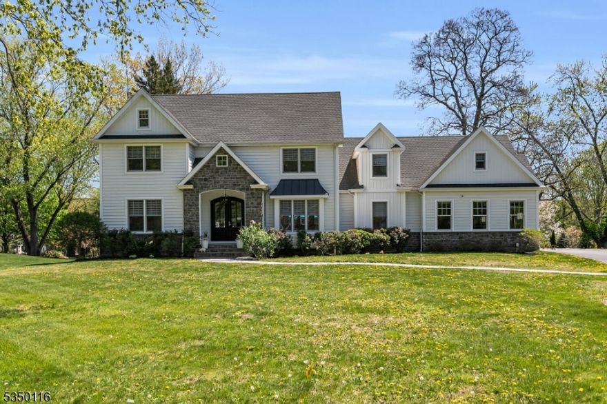 This stunning custom-built 5-bedroom home features a modern open floor plan, blending style and functionality perfect for both everyday living and grand entertaining. Step inside to discover hardwood flooring throughout, adding warmth and elegance to every corner of the home. Elevating the kitchen into a chef's paradise are the Carrera marble countertops, two islands, Italian cooking appliances and custom cabinetry showcasing exceptional craftsmanship. The living room is a showstopper, boasting high ceilings and a cozy gas fireplace, creating an inviting space for relaxation and gatherings. Adjacent, the dining room sets the stage for memorable dinners. The primary bedroom, conveniently located on the first floor, offers a serene retreat with a full bath with marble countertops, a soaking tub and spa shower as well as a walk-in closet. An additional en-suite first-floor bedroom provides flexibility for guests or a home office. A powder room, laundry room, and pantry complete this level. Upstairs are 3 spacious bedrooms, 2 sharing a well-appointed Jack & Jill bath and another full bathroom for added convenience. The enormous rec room is a standout, offering endless possibilities. The unfinished basement, pre-plumbed for a bath, awaits your person touch, ideal for a gym, media room, or extra living space. This truly remarkable home blends modern design, premium finishes, and thoughtful functionality into one irresistible package.