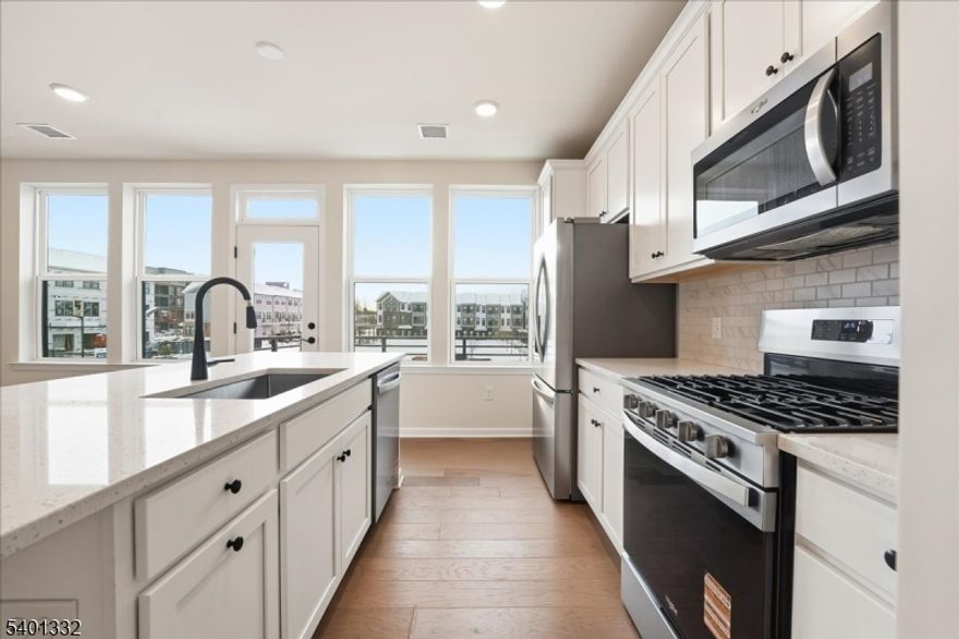 This stunning new construction townhome features a sophisticated open layout and a gourmet kitchen with a quartz island. Located minutes from Rutgers University, parks, fields, restaurants, shops, theater, and downtown, it offers 3 bedrooms and 2.5 modern baths, including a luxury primary suite. Large windows flood the space with light, leading to a private balcony. Additional perks include a dedicated laundry room and an attached garage. Modern style meets ultimate convenience.