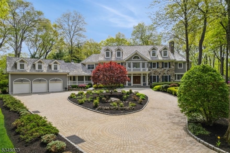 Situated in one of Mendham's most prestigious neighborhoods, this stunning custom home offers a blend of sophistication and modern luxury. Built in 1992, it sits on three-level acres on a cul-de-sac yet is just moments from vibrant downtown Morristown. This gated stone and clapboard exterior with a dramatic circular driveway is inviting. Inside the 5-bedroom residence is a grand two-story foyer, wonderful craftsmanship, Extensive custom moldings, six-panel doors, and hardwood floors. The light-filled, thoughtfully designed floor plan is ideal for large parties and intimate gatherings. The kitchen boasts a designed Leonardes kitchen with top-of-the-line appliances and a separate breakfast room overlooking the grounds and outdoor entertaining spaces. Large formal living room with a fireplace, dining room with a built-in closet, two-story Great Room with Stone fireplace, Mahogany Library with stone fireplace and built-ins, and a wonderful sun room. Second level- Primary suite is a retreat boasting a sitting room, a huge bathroom, and dual custom closets. Additional bedrooms have en-suite bathrooms and a jack and jill bathroom for privacy and comfort. The separate area over the garages is an exercise room and recreation room. The home's lower level boasts a media room with surround sound, digital control, wine cellar, billiard room, pub room, and full bathroom. Additional features include 3 car attached garage.