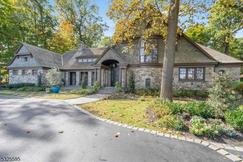 Experience the pinnacle of luxury living in this stunning Harding Township estate in Hartley Farms. Timeless elegance meets modern sophistication across every detail of this serene retreat.The breathtaking two-story living room features custom wood barrel ceilings and French doors that open to a tranquil bluestone courtyard. A state-of-the-art chef's kitchen, anchored by an oversized island, flows seamlessly into the dining and family rooms, perfect for both intimate gatherings and grand entertaining. A sunroom offers a serene sanctuary with inspiring views. The first-floor primary suite offers unparalleled luxury with high ceilings, a fireplace, two custom closets, a spa-inspired bath, and French doors leading to a private veranda. Nearby a private office with custom-built cabinets, its own exterior entrance, and abundant natural light, create the perfect space to work from home.The second floor boasts three en-suites, a living room, and plenty of storage. The lower level is beautifully finished with a wine room, golf simulator, gym with a sauna, expansive recreation room, and an additional en-suite bedroom.The beautifully landscaped exterior is a tranquil private retreat, ideal for relaxation. A charming pergola, fire pit, and outdoor kitchen create a perfect alfresco dining and relaxation space. A separate carriage house with a one-bedroom apartment and a three-car garage completes this estate, where privacy and luxury harmonize beautifully.