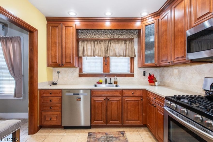 Spacious and move-in ready, this home offers a highly functional layout designed for everyday comfort. An insulated sunroom welcomes you upon entry, leading into a cozy living room with a wood-burning fireplace that flows seamlessly into the dining area. The well-maintained kitchen is conveniently positioned near the back mudroom, which provides access to both the kitchen and basement. The first floor features two bedrooms and a full bath. Upstairs, you'll find a spacious third bedroom with an attached bonus room   ideal flex space for a home office, den, sitting area, playroom, or exercise room. Brand-new carpeting throughout the staircase and second level, along with fresh paint, adds a crisp, updated feel. The fully finished basement offers additional living space along with a laundry area and workshop. Step outside to enjoy a fully fenced backyard complete with a gazebo, perfect for relaxing or entertaining. Conveniently located close to major transit, highways, shopping, and dining, making everyday living and commuting a breeze.