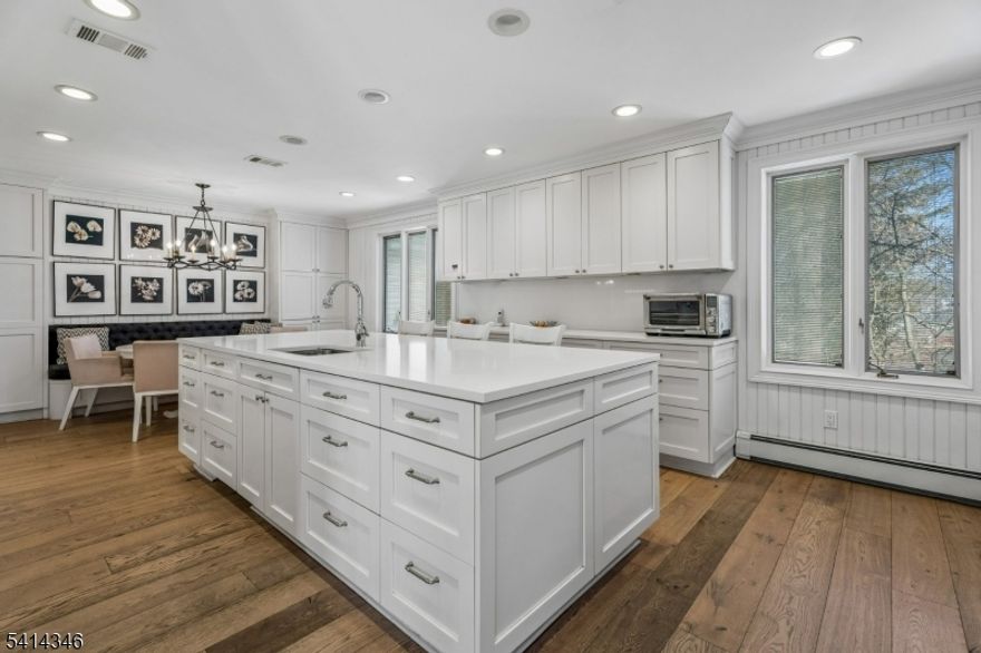 Welcome to this deceivingly large custom home in the heart of Pleasantdale. Tucked away on a dead-end street, this home boasts a mix of traditional & modern updates. Wide plank oak floors, large rooms & generous closets are found on all three finished levels. The spectacular kitchen, designed by Mary Douglas Drysdale, isn't only stunning but also a chef's dream; adorned with top-of-the-line appliances and surrounded by loads of cabinets & generous Caesarstone quartz countertops affording great prep & buffet space. The first floor has a wonderful flow for relaxing and entertaining guests. With six bedrooms, the primary bedroom en-suite is on the first floor, plus four bedrooms upstairs and an additional bedroom in the basement. This home has a working elevator and is accessible to people with disabilities, accommodating all lifestyles. Other highlights include a new roof (2024) and a new CAC (2023). Walk to nearby Houses of Worship and schools; steps from a FREE jitney/shuttle bus to NJ Transit trains to NYC; easy access to major highways and parks & recreation.