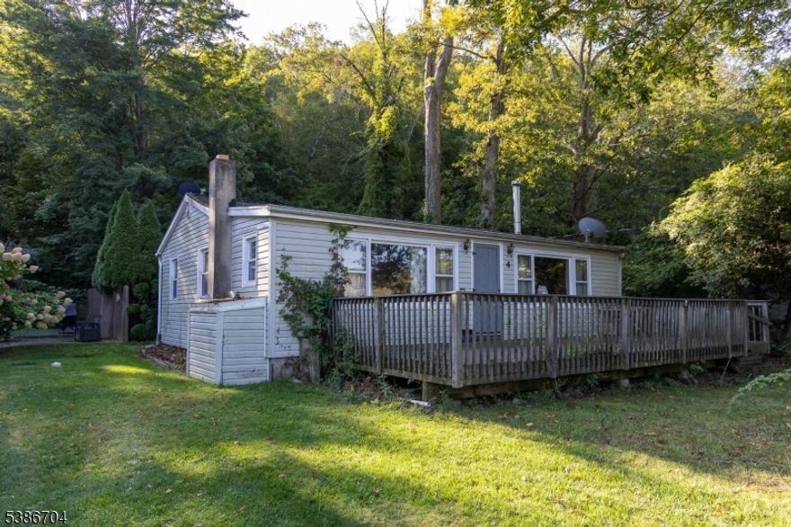 Charming Ranch-Style Home with Lake Views! Welcome to your cozy retreat. This delightful ranch offers 2 bedrooms and 1 bathroom. As you step inside, you'll be greeted by hardwood floors that flow through out the living areas, adding warmth and character. This inviting layout features a spacious living room that connects to the dining area creating an ideal area for everyone to gather. Living room has a wood burning stove, perfect for gathering around in the winter. The kitchen includes a skylight for extra natural lighting, and is easily accusable from the driveway. Located in a tranquil setting, this home offers a perfect blend of comfort and nature. One of the stand out features of this property are the stunning views of Kittatinny Lake right from your own front porch. This home is walking distance from the lake, basketball court, playground, and clubhouse. Short drive to restaurants, Appalachian hiking trails, and Sunrise Mountain. Monthly HOA fee's. Oven portion of the stove does not work, buyer accepts the oven as is. Septic failed, seller willing to negotiate repair or credit.