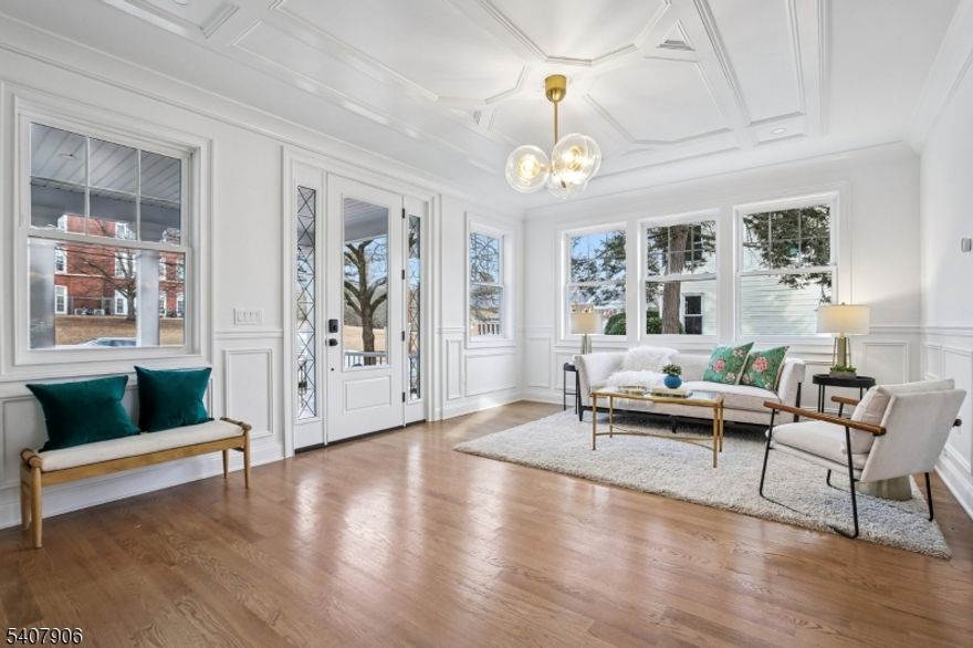 A rare opportunity to own a spectacular, fully renovated home just steps from Maplewood Village and the Maplewood train station. This 1908 residence has been completely rebuilt inside and out, offering the feel of brand-new construction with timeless charm. With 7 bedrooms, 6 full baths, 1 half bath, and backing directly to the golf course, the location is hard to beat. The renovation was completed by Lefko Brothers, known locally for honest work and quality craftsmanship.The first floor offers a formal living room, private office, gourmet kitchen, formal dining room, and a spacious family room with fireplace. A first-floor guest/in-law suite with en-suite bath adds flexibility. The attached two-car garage opens into a custom mudroom with a massive coat closet. The second floor includes four generous bedrooms: two share a Jack and Jill bath, one is a junior suite with private bath, and the primary suite is exceptional with vaulted ceilings, a double-sided fireplace, beverage station, two oversized walk-in closets, and a spa-like bath with soaking tub, oversized shower, double vanity, and private commode room. The third floor adds another bedroom and full bath. The finished walk-out lower level features a rec room, office, bedroom, and full bath. Everything is brand new, including siding, windows, roof, electrical, plumbing, HVAC, and appliances.