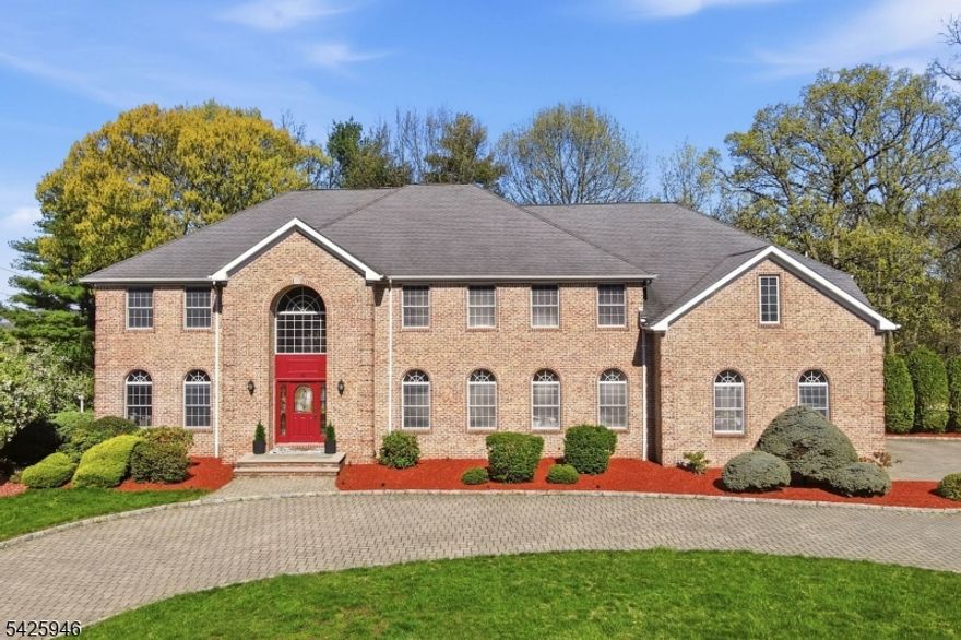 Rare opportunity to own a truly exceptional, resort-like property offering approx. 5,000 sq ft across 2 expansive levels, with room sizes & proportions rarely found in newer construction. This timeless, brick-front Center Hall Colonial, built by a premier builder using materials designed to last a lifetime, combines enduring quality with incredible scale on a beautiful, flat 1/2 acre lot in a desirable neighborhood. A grand 2-story foyer with a sweeping staircase opens to formal living and dining rooms, a private office & a dramatic great room with a fireplace. Hardwood floors span much of the home. The gourmet kitchen features granite countertops, a center island, & ample gathering space. A flexible layout includes a main-level bedroom with a full bath, convenient first-floor laundry and a deck off the kitchen. Upstairs offers oversized bedrooms and a massive primary suite, along with a bonus room ideal for a home office, playroom or lounge. The full walk-out unfinished basement is perfectly usable today and ready to be transformed into a theater, gym or recreation space. Set on a large, flat lot with room for a pool, 6 zone sprinkler system, the home also features a circular paver driveway and a 3-car garage. All this, ONLY $26,575 IN TAXES. Lovingly maintained and completely livable as-is, it offers the rare opportunity to personalize over time blending immediate comfort with long-term value. NOT TO BE MISSED!