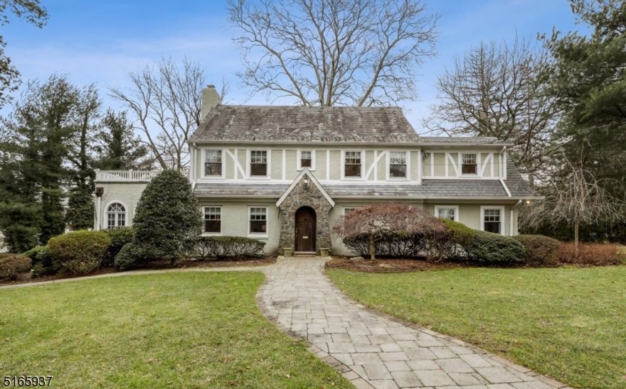 Welcome to this beautiful 4 BR, 5 full and 2 half bath center hall Colonial with stucco exterior, slate roof, high ceilings and gleaming HWD floors. As you enter the home, you are greeted by a lovely foyer that leads to a large living room, featuring front and rear windows that provide generous natural light and a wood burning fireplace. The dining room, with a corner built-in cabinet, offers a warm and inviting atmosphere. The huge wonderful family room boasts three walls of gorgeous windows and a wood burning fireplace. The eat-in kitchen offers great views of the patio and backyard and is equipped with SS appliances and white cabinets w/granite countertops. A terrific office and fabulous powder room complete the first level. The second level offers three en-suite bedrooms with generous walk-in closets and updated bathrooms. The primary bedroom has access to a large balcony, offering a peaceful retreat for the owners. The third floor features an additional bedroom, full bathroom and cedar closet. The expansive basement houses a large rec room, powder room, office w/ensuite full bath, laundry room, plentiful storage and access to the heated 2-car garage. New boiler (2023), water heater (2022), two dishwashers (2022), refrigerator (2021), whole house generator (2013) and mostly new windows (2009.) Top-rated Millburn schools, shopping, restaurants, Short Hills train station and easy access to many highways await the next homeowners.