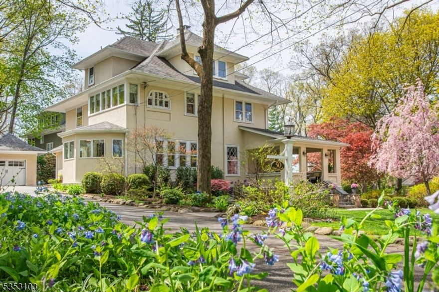 This exquisitely renovated & meticulously maintained four square Hapgood colonial is an architectural gem, offering a perfect blend of historic charm & modern elegance. The charming open-air covered porch is where you can watch the sunset behind the main lake. The elegant LR is adorned w/wood-burning fireplace. Sunlight floods the FR, while the banquet-sized DR impresses with a fabulous bar area, seamlessly open to the gourmet kitchen; top-of-the-line SS appliances, custom cabinetry, dual-ovens & microwaves & an expansive center island. A powder rm & mudroom complete the 1st fl. The 2nd fl features a  sun-drenched primary suite with his/her custom closets, hardwood flrs, charming arched ceiling details & a marble bath w/ dual vanity, heated floors & seamless, glass rain head shower. 3 ample bedrooms & updated hall bath provide plenty of space for all. The 3rd fl has 2 spacious  bdrms  w/lge closets, a spacious cedar closet & hall bath w/an open wet room style shower/tub & lndry rm. The LL is home to a rec area w/a game room, gym area, wine storage & dry storage. A detached 2-car garage is equipped w/ a high speed EV charger. Commune w/nature & relax on the private, bluestone patio complete w/a built-in fire pit, stone walls & a hot tub. Move in & embrace all that ML has to offer: close to top rated schools, NYC transportation & Midvale boat dock for lake activities. With new 2024 A/C & 2023 furnace, this home is turnkey ready for you to enjoy a lifestyle of comfort & luxury.