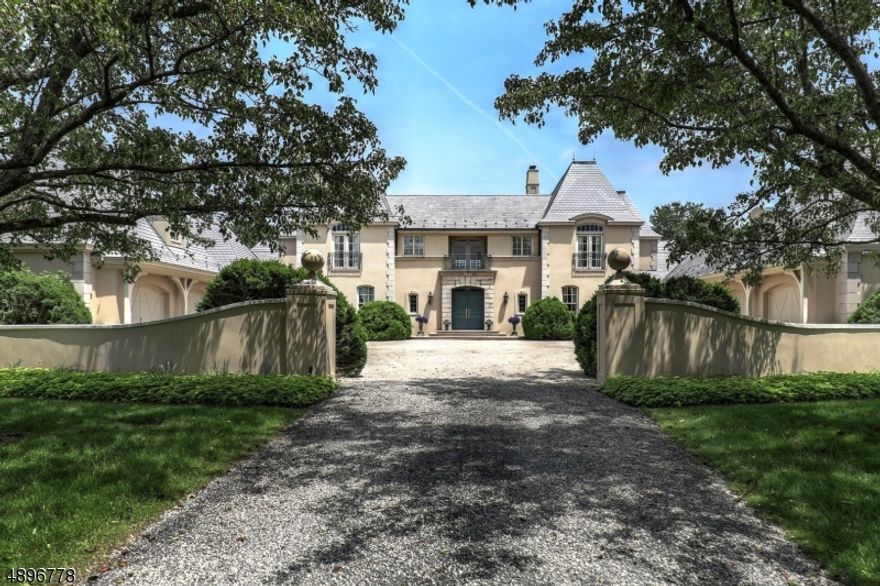 A long winding drive with dynamic views of rolling fields and woodlands opens to an expansive courtyard flanked by 4  garages. This elegant French Manor Home with slate roof is sited at the summit of 59  farmland assessed acres (2 separate parcels) in the heart of Hunt Country. Lush gardens, a fruit orchard, fenced paddock, stone patios, walls & walkways & an idyllic pond highlight the magnificent grounds. Quality craftsmanship & extensive architectural detailing are evident throughout: high ceilings, arched doorways, uniquely designed custom windows, 4 fireplaces, paneled library & gourmet kitchen with adjacent breakfast room that overlooks deep rolling lawns. French doors throughout connect the interior spaces to the scenic outdoors.