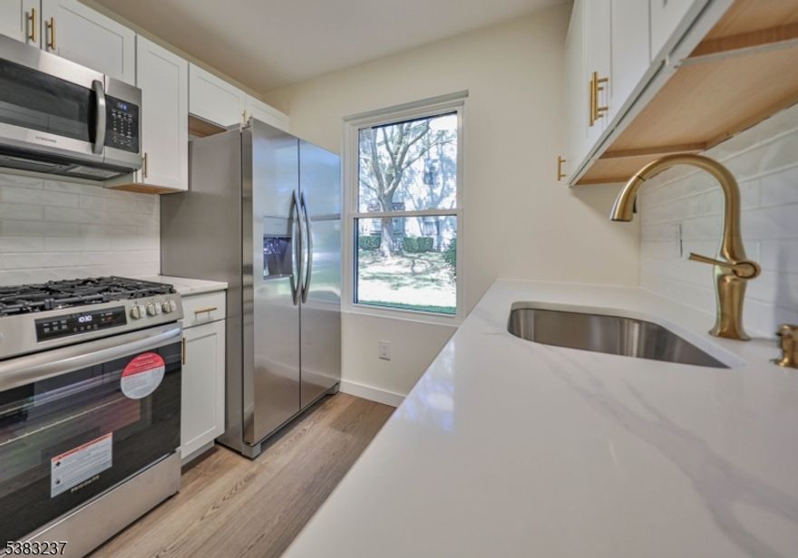 Welcome to this beautifully renovated first-floor end unit in the desirable Spruce Hills community. This spacious condo offers a large living room, dining area, and three generous bedrooms, providing plenty of comfort and flexibility.Enjoy a private setting as the unit backs onto a large wooded lot perfect for sipping your morning coffee while listening to the birds yet you'll still get all the benefits of community living, including lawn care, snow removal, and access to top-notch amenities like the pool, clubhouse, tennis courts, and walking paths.The home features a modern, fully renovated interior with quartz countertops, luxury vinyl plank flooring, and all-new stainless steel appliances. The building itself has also been updated with new siding, adding to its fresh, modern appeal.Located close to major highways, this home offers easy commuting while still delivering a peaceful, nature-filled lifestyle. Move right in and enjoy low-maintenance living at its finest!