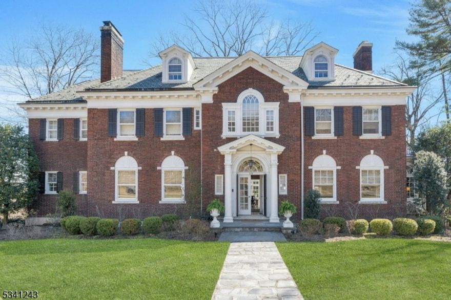 Stunning historic brick Georgian built in 1915 by Abraham Lincoln Burbank! Elegant, stately exterior of this 5BR 4.2BA estate leads way to a warm and inviting interior, flooded with natural light. Original architectural details- picture & triple crown moldings, 11ft. ceilings, 5 fireplaces, leaded glass & Palladian windows add distinction to this home that blend seamlessly with its contemporary finishes- perfect for entertaining & comfortable living. 1st floor boasts a grand entry staircase, gleaming quarter sawn oak floors, bright and spacious dining and living room w/ marble & soapstone fireplace, large, updated EIK w/ pantry, lovely sunroom, library w/ crafted millwork w/ French doors leading to terrace overlooking manicured yard. 2nd floor features expansive primary suite & dressing room w/ new white oak floors throughout, spa bath, 2 additional large BR w/CC closets & adjoining bath, office w/custom oak shelving w/secret door, & solarium. 3rd floor offers two large, sunny bedrooms w/ full baths & cedar storage. Numerous upgrades including newly finished lower-level rec room w/built in entertainment ctr & storage, full gym room & craft room w/ walkout to bluestone patios, firepit area & playground, underground sprinklers, CAC, EV charging station, 2 car garage w/ loft (possible studio apt.) Seasonal views of NYC sunrise & glittering skyline! Ideally located minutes away from vibrant Upper Montclair & Watchung Plaza shops & restaurants, parks and NYC train station.