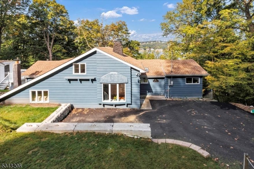 Nestled in Sparta's scenic Lake Mohawk Country Club section, this beautifully renovated 2-bedroom cottage offers a perfect blend of charm and modern convenience. Featuring an open-concept living space, the home boasts updated finishes throughout, including a sleek kitchen with stainless steel appliances, hardwood floors, a renovated bathroom, and a new septic system. Original Lake style, pecky vaulted ceilings, and skylights. Hardwood floors, stone fireplace, plus loft. The spacious bedrooms are filled with natural light, offering tranquil views of the surrounding greenery. The crown jewel of this property is the unobstructed view of the lake, which can be enjoyed from both the living and the expansive outdoor deck " perfect for relaxing or entertaining. This cottage is an ideal retreat forthose seeking lakeside living in a serene, picturesque setting.