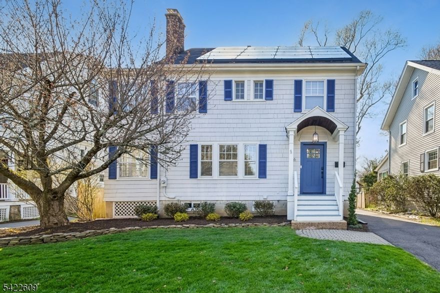 A picture-perfect three-bedroom, two full-bath Colonial in a prime neighborhood location near Summit's vibrant downtown and NYC trains. Situated in the Lincoln-Hubbard Elementary School district and just steps from Wilson Primary Center and Wilson Park, this home blends charm with modern updates. Freshly painted 2026 interior is complemented by a 2020 kitchen and dining renovation. A welcoming entry leads to a spacious living room with a woodburning fireplace and luxury vinyl flooring. The dining room and eat-in kitchen feature durable hardwood-style ceramic tile. The updated kitchen offers white cabinetry, stainless steel appliances, a coffee bar, and pantry, with access to a 2024 Trex deck overlooking a level yard with smart irrigation, shed, and detached one-car garage with new roof, windows and siding. A bright den/playroom with built-ins completes the first floor. Upstairs are three bedrooms, including a primary suite with dressing room and double closets, plus a versatile office or nursery and full hall bath. The finished lower level adds recreation space with new 2026 carpeting, a full bath, laundry, refrigerator and ample storage. Additional highlights include solar energy, high-velocity HVAC, and a 2023 furnace.