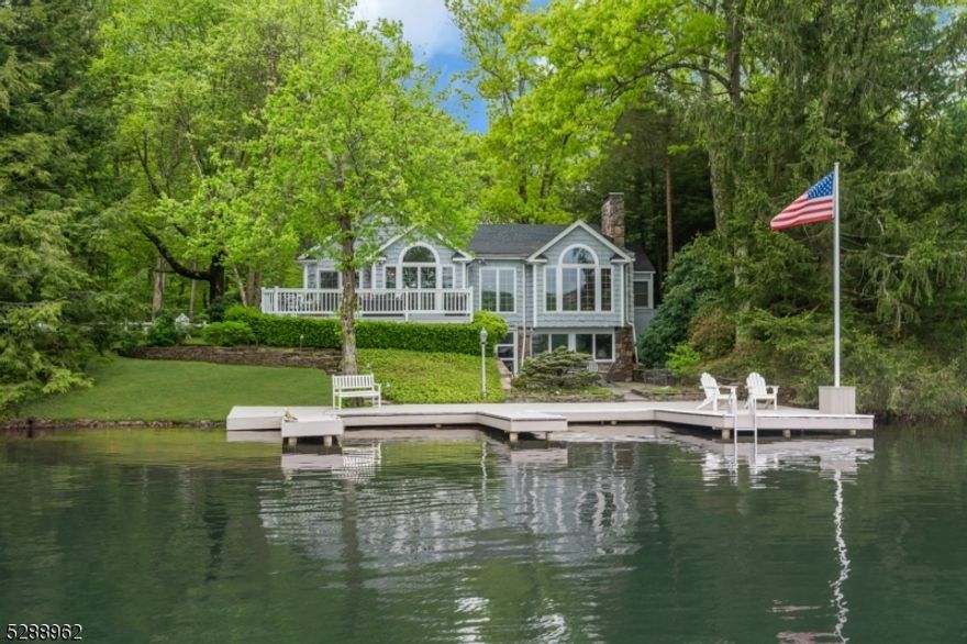 Nestled on the shores of the private community of Lake End Corporation, Green Pond, NJ's cleanest lake, this elegant lakefront residence is encompassed by 1.8 acres of pristine wooded terrain. Meticulously renovated and modernized, this cherished abode boasts 4 bedrooms and 3 full baths, affording enchanting vistas of the tranquil waters.The main level, adorned with expansive floor-to-ceiling windows, embraces an open-concept design, seamlessly merging the dining area, kitchen, and sitting room, all framing the awe-inspiring lake panorama. The living room, featuring a custom fireplace and thoughtfully crafted built-ins, along with 2 bedrooms and 2 full baths, further elevate the main level's allure. Descending to the lake level, a walk-out layout unveils 2 additional bedrooms, 1 full bath, a recreation room replete with a fireplace, and a summer kitchen accompanied by a laundry room.Beyond the interiors, the meticulously landscaped grounds stretch from the front to the rear, crowned by a spacious deck and a serene blue stone terrace that gracefully transitions to three year-round docks. Completing this idyllic portrait is a 3-bay garage with ample overhead storage.Whether seeking a weekend retreat or a year-round haven, this exquisite dwelling and its enchanting backdrop are an opportunity not to be overlooked. The golf cart friendly community of Green Pond, is only 1 hr from NYC. Activities include, motor boating, sailing, swimming, tennis & pickle ball.