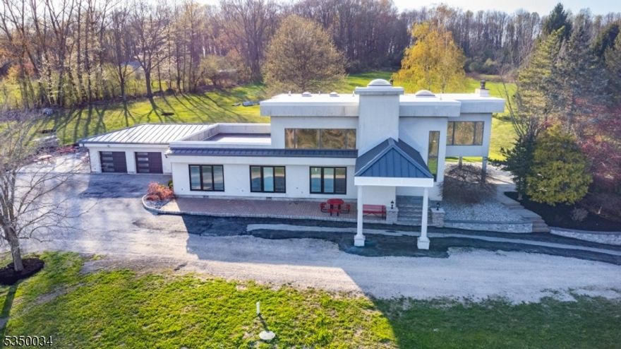 Savor the stunning views and peaceful ambiance of country living on this 35.80-acre farm-assessed property. New impressive 50' x 100' x 25' Pole Barn, offering versatile space for equipment, workshops, or agricultural needs. Updates include New Septic 1 yr old, Roof 2 yrs old. The estate features a welcoming 4-bedroom home, complete with an attached bonus room that includes a full bath. Throughout the home there are breathtaking panoramic views and floor-to-ceiling windows. The living room, featuring a cozy wood-burning fireplace, seamlessly connects to the kitchen. The kitchen is equipped with high-end appliances and opens up to a spacious outdoor patio, ideal for entertaining. Enjoy the flat, expansive backyard.   Thermoplastic Polyolefin (TPO) top roof significantly reduce cooling costs, complimented by durable metal roofing for maximum protection and contemporary appeal. Newly installed Equinox wood-burning stove. The property's farm-assessed status offers the advantage of lower land taxes. This home is the perfect escape!