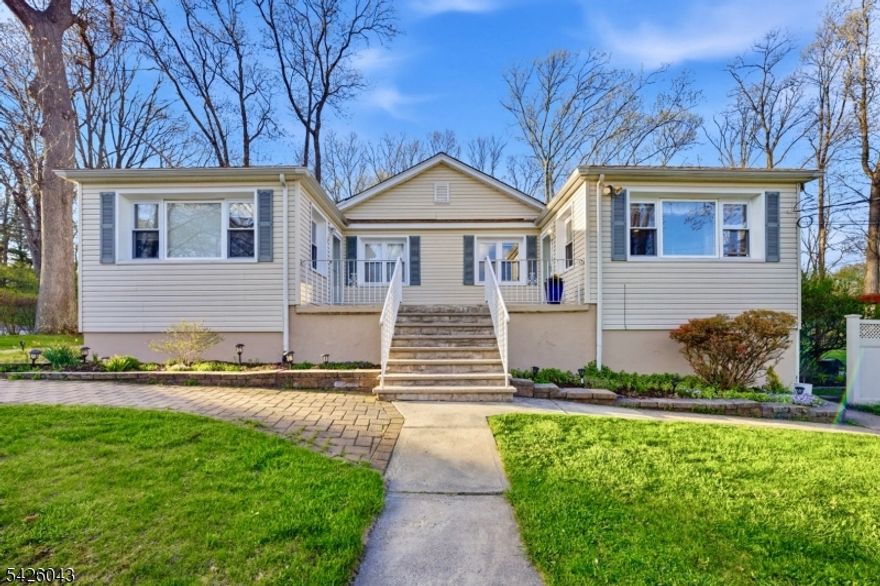 Exceptional Owner Occupied Two-family Opportunity in the Heart of Randolph! Perched on more than half an acre with a beautifully landscaped lot, classic stone wall border, and two separate driveways, this expansive raised ranch delivers two fully independent living units plus a massive lower-level, all within the top-rated Randolph Township School District. Unit 1 features a sun-drenched kitchen with rich cherry cabinetry, stainless steel appliances, and a wall of windows overlooking the yard, flowing into a generous dining room and living room with warm hardwood floors. One main-level bedroom plus a renovated full bath with floor-to-ceiling tile, frameless walk-in shower, and pebble mosaic floor. The finished lower level adds four more bedrooms, a family room, gym space, an updated full bath, laundry room, and its own exterior exit. Five bedrooms total with incredible flex space for flexible living arrangements. Unit 2 is fully self-contained with its own private entrance and driveway, featuring an open kitchen and living area with hardwood floors, two bedrooms, and a full bath, and laundry, ideal for offsetting your mortgage or as a turnkey investment. Both units have separate utilities and mechanicals. Outside, enjoy a fully private yard with pergola, paver patio, fire pit, and sweeping lawn with mature trees. A detached two-car garage and two dedicated driveways complete this rare package. Minutes from Route 10, I-80, NJ Transit, and all that Randolph has to offer.
