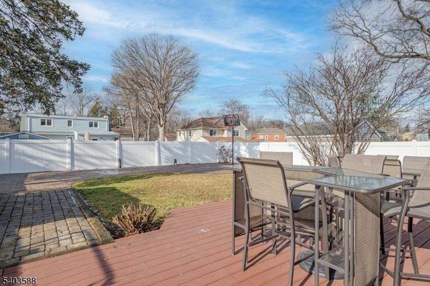East-facing colonial home featuring a classic brick front, paver driveway, and inviting walkway leading to a bright, open foyer with a stunning chandelier and abundant natural light. The main level offers 10-ft ceilings, a spacious LR and DR combo with HW flooring, accented by elegant columns that define each space with timeless appeal and enhanced by a built-in surround sound system. The gourmet kitchen features SS appliances, a center island with seating, a mini bar/butler pantry. Custom windows on the first floor enhance natural light throughout. Sliding doors open to a fully fenced backyard with a paver patio and lawn, perfect for outdoor enjoyment. The family room offers HW flr, classic columns, a step-down design adding architectural character, and a conveniently located powder room. The first floor hallway connects to the laundry and pantry area and provides direct access to a two-car garage. The second level overlooks the foyer and offers a spacious primary bedroom with 8+ foot ceilings and a luxurious en-suite bath featuring a stall shower, jacuzzi tub, and two closets. Three bedrooms feature large windows and ample closet space. A full hall bathroom includes a tub and a double vanity. The unfinished basement has nine-foot ceilings, offering excellent potential for future customization. The whole house has central vacuum. Ideally located near the GSP, NJT,  287 & 1, shopping, dining, and Metropark Train Station.