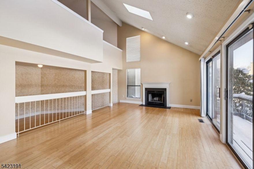 Welcome home to 18 Woodhill St, a beautifully maintained 2-bedroom, 2.5-bath townhouse offering space, style, and convenience. This home features hardwood floors throughoutand a stunning two-story living room filled with natural light, creating an open and airy feel. Keep warm and cozy with the wood burning fireplace. Use the loft for a home office or flex space!The modern layout flows seamlessly to an outdoor patio, perfect for relaxing or entertaining. Both bedrooms include sliders to private balconies, providing a peaceful retreat and fresh airright outside your door. Additional highlights include a private garage, ample storage, and well-appointed bathroom