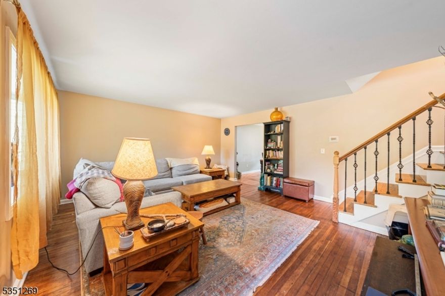 Move-in ready split-level home in the desirable Sunnyside section of Linden! The ground floor welcomes you with a bright living room with hardwood floors and an updated kitchen featuring a center island, ample cabinetry, and space for a cozy breakfast table. Off the kitchen, you'll find a versatile den perfect for a home office, playroom, or creative space with direct access to the attached garage and an unfinished basement offering plenty of storage. The second floor includes two comfortable bedrooms and a full bath, while the third level offers a spacious additional bedroom, ideal for a primary suite or guest room. Central AC and heating for convenience. Solar panel for energy efficiency. Enjoy a great-sized, fenced-in yard perfect for outdoor entertaining. Conveniently located near shops with easy access to the Garden State Parkway and major highways. A great layout with endless potential don't miss this opportunity!