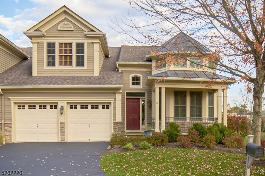 Rosevalle! Nestled within an elegant Townhouse Community of spacious homes built around 2007, this end unit home with views of the pond is sun-filled and welcoming. High Ceilings, elaborate crown moldings, abundant windows, solid doors and hardwood floors, and a gracious floor plan that creates a sense of space and elegance.  A two-story entry introduces a wide, pillared entry into a formal dining room or library with lovely bowed shuttered windows.  There's an open concept kitchen-breakfast area room with two-story ceiling and windows.  High-end appliances, Wolf wall oven, built in microwave and warming tray, sub-zero refrigerator/freezer, wine fridge, Wolf six-burner cooktop and oven, plus a tiered center island for breakfast bar seating and a Miele dishwasher. The great room -LR-DR has agas-log fireplace with recessed TV bay with glass backed built-ins.