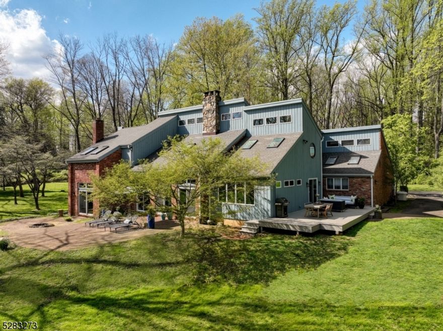 **Currently a three bedroom septic, Designs in hand for a new five bedroom septic system.** Tucked away down a stately private drive sits a newly updated contemporary sanctuary situated on 3.1 park-like acres in desirable Harding Township.  11 Gleneagles Drive offers supreme privacy while being just minutes from the conveniences of Morristown, Madison and Chatham. Step into a haven featuring soaring ceilings, a massive Pennsylvania stone fireplace,  sunken living room, and a sun-washed family room.  The kitchen boasts top-of-the-line appliances, complimented by two outdoor living spaces that are perfect for entertaining.  Upstairs, three bedrooms share space with a separate two-bedroom guest quarters providing flexible accommodations for every need.  With excellent schools, low taxes and easy access to midtown-direct, this private oasis is within your reach!