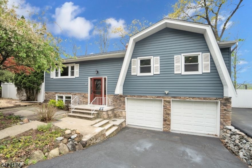 Beautifully maintained bi-level home set on a quiet street in Wanaque, offering scenic views and a private backyard retreat. A large deck provides the perfect space for outdoor entertaining, with easy access from the eat-in kitchen, allowing for seamless indoor-outdoor living. The main level features a bright living room, formal dining room, three bedrooms including a primary suite with its own full bath, and an additional main bathroom. The lower level offers a spacious family room, convenient half bath, laundry room, and ample storage, along with an oversized two-car garage. Nestled near the picturesque Wanaque Reservoir, the town is known for its peaceful, wooded surroundings, scenic mountain views, and easy access to major highways and New York City, making it an ideal blend of privacy and convenience.
