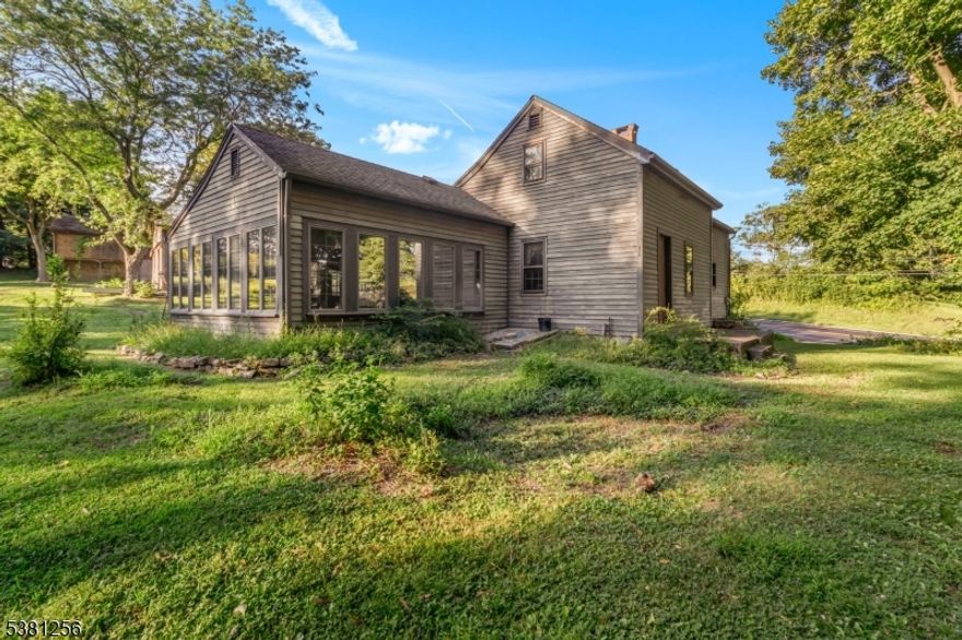 Historically known as the Hall House and built circa 1750, this property is one of the oldest homes still standing in Warren County. Many of the original interior details remain, including hewn framing timbers, pine floors, chair rails, and beaded window and door trims. On the first floor, the dining and living rooms contain two historic fireplaces which can be used for decorative purposes, as well as an extra room which can be used as an office. The sunroom, added in approximately 1983, provides ample space to relax and plenty of natural light. Upstairs are two bedrooms accessible via separate sets of Jersey Winder steps. Outside are two barns - one large and one smaller - with versatile potential under CO-1 zoning. The main barn can be used for agricultural purposes or converted into occupational or commercial use, while the smaller barn can be used as storage or garage space. With some TLC, the property can offer a unique blend of historic charm and modern living or business use!