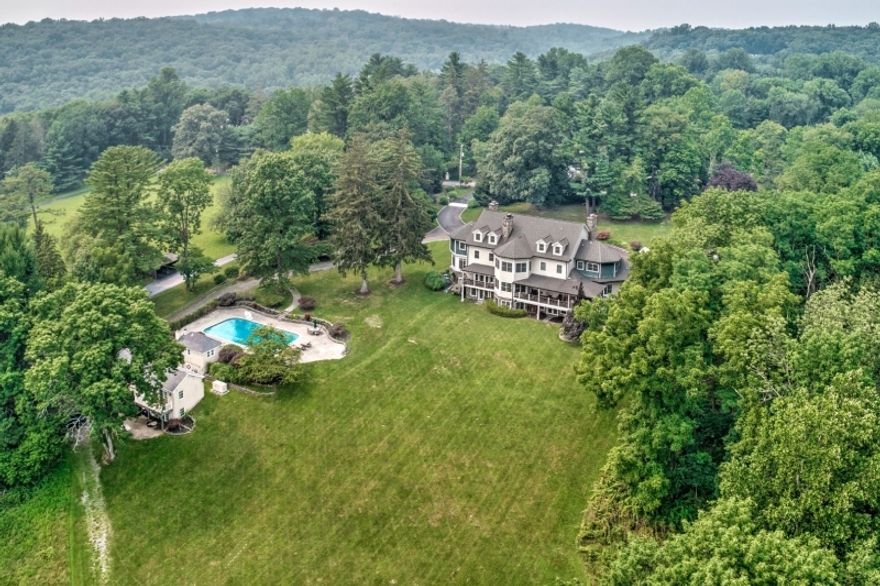 COUNTRY MANOR + CHARMING COTTAGE- Gates open to welcome you to this one-of-a-kind residence which accommodates today's needs for work and recreation. The tranquil, private, 8-acre setting is 1.4 miles from the crossroads in quaint Mendham Village. Versatile use cottage suitable for home office, studio, guests, or multi-generational living. Enjoy peaceful pastoral views from the comfortable wrap-around porches featuring a large dining area and outdoor grill. Through the stunning custom front door, step into the Foyer with 20 foot soaring ceiling. The feelings of light and spaciousness continue throughout this 18 room home with 10,000+ square feet of living area including finished walk-out lower level with radiant heat, exercise rooms and wine cellar. Beautiful views command your attention through the walls of windows in every room. Patio with fire pit conversation area, heated salt water pool, pool house, charming 2 bedroom cottage, small barn, and 5 garage spaces complete this very desirable property. Start making memories in Mendham.