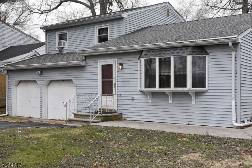 Spacious with Master Bedroom on the first floor, 3/4 bedroom, 2 full bath colonial with 2 car garage situated on a nice size fenced-in lot. First floor open floor plan, perfect for entertaining, with bamboo floor, recessed lighting, sliders to deck/patio  off the DR, open view of custom kitchen with granite counters, SS and black appliances, comfortable size breakfast area. Second floor is hardwood with 2 bedrooms  (one bedroom can be converted back to 2 BR) , dual heating, gas and electric, full bath, mirrored closets. In-law suite possibilities. It is Waiting for you. Sales is AS IS