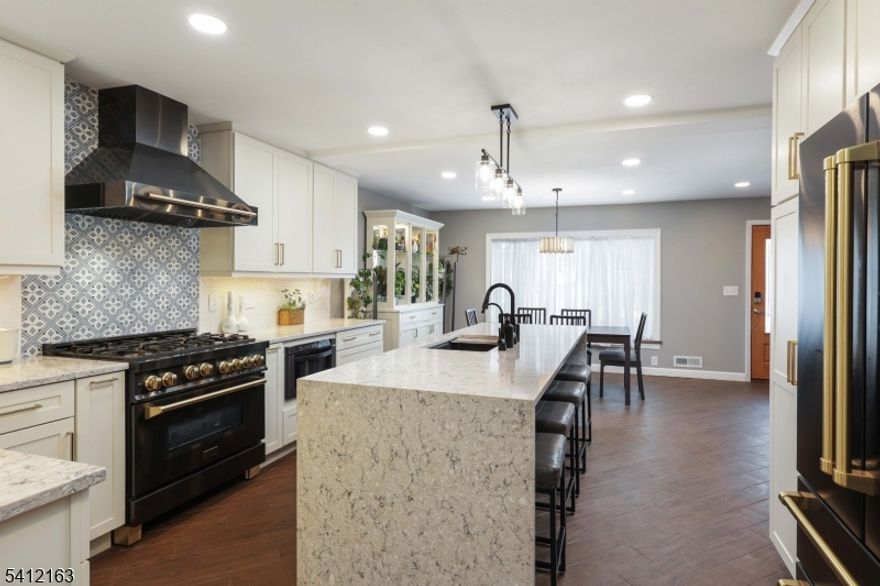 This custom Cape is so much more than just a Cape!!!!  Boasting approx 2500 sq ft of living space, this 4 bedrooms and 3 full baths home is perfectly designed for entertaining inside and out. The kitchen of your dreams is the heart of the home, showcasing high-end Z Line appliances, a stunning quartz island, abundant cabinetry, and a spacious pantry--ideal for hosting gatherings both large and intimate. The inviting living room features a wood-burning fireplace and sliders that open to a deck with pergola and outdoor TV, creating seamless indoor-outdoor living. Enjoy summer fun in the above-ground heated pool, plus a greenhouse and a finished basement with den, full bath, laundry area, and workshop. Come and take a look at this stunning home.