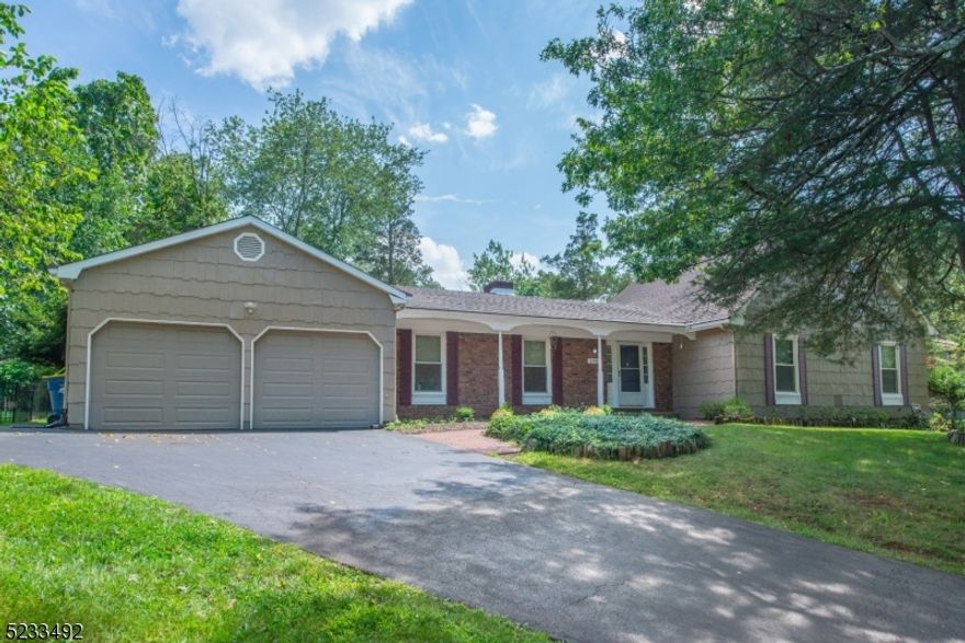 This fantastic colonial style expanded ranch offers five bedrooms, including a first-floor primary suite with a full bath. The partially finished basement provides extra space for your needs. Outside, you'll find beautifully maintained perennial gardens in a great neighborhood. The house is conveniently located near shopping, dining, major arteries like Routes 287, 22, and 78 making commuting a breeze, along with the ability to make quick day trips to the Jersey Shore. The brick fireplace, hardwood floors and recessed lighting add to the charm. The kitchen features newer upgrades like granite countertops and a subway tile backsplash. With public utilities and natural gas, you'll enjoy ease and efficiency. The level yard is perfect for outdoor activities.  French doors lead to the three-season room, complete with a dry bar and door to the backyard;  an ideal space for entertaining. This home is move-in ready with updated kitchen and baths, so you won't have to lift a finger. It's a dream come true!