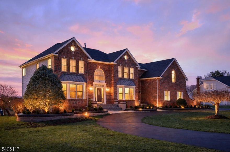 Stunning brick-front colonial offering 5 bedrooms, 3.5 baths & approx. 4,134 sq ft of beautifully updated living space. A grand two-story foyer w/ hardwood floors sets the tone, flanked by a private office w/ custom built-ins, wainscoting, & recessed lighting. The elegant dining room features hardwood flooring, tray ceiling, chair rail, & decorative columns. The spacious kitchen is designed for both function & style, boasting a large center island, granite countertops, coffee station, & newer cooktop & dishwasher. The inviting living room offers bay windows & recessed lighting, while the dramatic two-story family room showcases skylights, a second staircase, & a floor-to-ceiling whitewashed brick wood-burning fireplace. A well-appointed laundry/mudroom with exterior access and an updated powder room complete the main level. Upstairs, the luxurious primary suite features double-door entry, a spa-like bath with quartz dual vanity, jetted tub, separate shower, private commode, & an exceptional walk-in closet with custom built-ins, ironing center, valet, and jewelry storage. Bedrooms 2-5 include custom closets, and recessed lighting. The basement offers epoxy floors, shelving and direct access to the 3-car garage. The exterior offers a  spacious open yard w/ sweeping views & composite deck (2022). Additional highlights: Roof (2019), 2 HVAC's (2018) ext. lighting, sec system, Ring doorbell, smart thermostat, Tesla charger, New HW Floors (2020) and custom blinds throughout (2024).