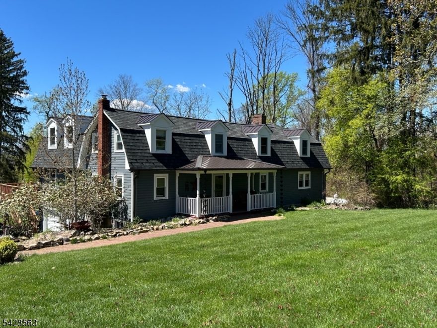 This beautifully expanded custom colonial blends classic charm with thoughtful updates, set on a beautifully landscaped lot surrounded by farm fields & mountain views. Offering four bedrooms & four full baths, the home has been renovated while maintaining its warm, inviting character. The paver walkway w pillars & lighting creates a lovely entrance. A covered front porch graciously greets your guests & opens to a sizable foyer. Many rooms w hardwood flrs. The standout 25x22 gourmet kitchen is perfect for both everyday living & entertaining, featuring a large granite center island, stainless steel appliances, a 6 burner Thermador range w hood, beverage frig, track lighting, beamed ceiling, custom cabinets & 2 sliding glass doors to deck. The den features a pellet stove & built in cabinets. First Flr full bath w a claw foot tub & closet storage. Spacious Living Rm w beamed ceiling & Dining Rm. Step down family room with wb fireplace, beamed ceiling with door to wrap-a-round deck and staircase to lower level office. Primary ensuite bedroom with skylights and bath with jetted tub & stall shower. Three additional bedrooms and convenient 2nd floor laundry. Whole house generator. Recent updates include a high end designer shingled roof, Azek exterior trim and a full exterior repaint. The in ground gunite heated pool with a refinished interior completes the outdoor space. A special home that offers the perfect mix of vintage style and modern comfort in a truly beautiful setting.