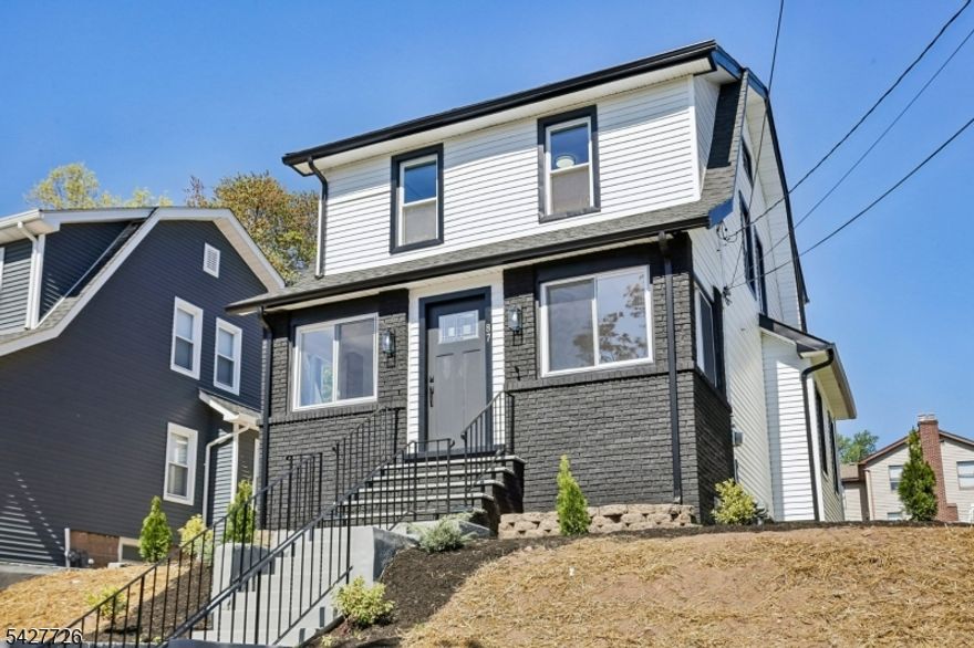 Welcome to 87 Edison Avenue, a beautifully renovated home nestled in the highly desirable and sought-after township of Nutley. This well-designed 3-bedroom home offers impressive curb appeal, a stylish exterior, and a welcoming first impression from the moment you arrive. Set above the street with a defined front approach, this home features wide concrete steps, sleek black railings, exterior lighting, fresh landscaping, and a modern black-and-white color palette. The exterior showcases a tasteful blend of light siding & dark brick accents, creating a crisp and contemporary presentation while maintaining classic neighborhood charm. . As you walk in, your eyes will be immediately captivated by the new, modern flooring throughout. The front door opens to a well-placed enclosed porch, providing extra room for a sitting area or storage. Once you walk past the enclosed porch, you are greeted by a large living room complemented by a well-designed accent wall. Continuing through the home, you will find a modern kitchen featuring white cabinetry, stainless steel appliances, and an open layout that flows into the dining room. Upstairs, where the 3 bedrooms are perfectly situated, you are welcomed by beautiful iron railings and 3 spacious bedrooms. This home does not stop impressing there. Downstairs, the finished basement offers additional finished space with endless possibilities. This home also features new HVAC system and a well situated laundry room.