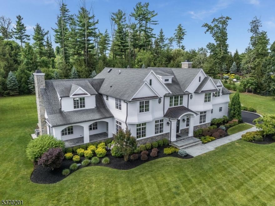 As the street name implies, this distinguished cul-de-sac home benefits from the privacy of its wooded surroundings.  A gracious floor-through foyer welcomes you into a classic center hall colonial, with a clear line of sight through to the bluestone patio. The delightful kitchen features a coffered-ceiling, a marble center island with wraparound seating, Thermador appliances, and a generous breakfast area. The elegant formal living & dining rooms are enhanced by wood flooring and custom millwork, with a versatile butler's pantry/bar, and a side exit leading to a charming, covered bluestone porch with teak ceiling: likely to become your favorite place to relax. Convenient first-floor bedroom or office with full bathroom. Upstairs, there are 5 spacious bedrooms, all with wood flooring, and four full bathrooms: three exclusive ensuite, one shared. The luxurious primary suite boasts a private balcony, vaulted ceiling, chandelier, two walk-in closets; its ensuite bathroom is an oasis of white marble with radiant floor heat, towel warmer, two vanities, shower and soaking tub. Finished lower level equipped for entertainment: open recreation area, golf-simulator/home theater, well-appointed wet bar with wine fridge & ice maker, gym area, full bathroom. Bluestone patio offers superb outdoor entertainment space, overlooking the private back yard. Three-car attached garage, plus extra detached two-car garage to accommodate your hobby or collection. Long range ridge views are a bonus.