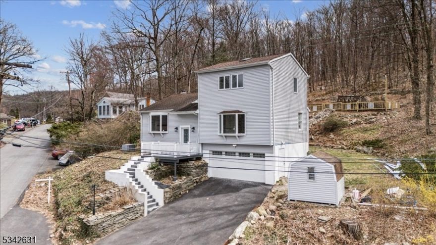 Stunning fully renovated, bright & sunny, large single-family home in Lake Hopatcong with year-round lake views! Located in Brights Cove at the north end of Lake Hopatcong, enjoy all the conveniences of urban living in a lake-like setting. Just minutes to dozens of restaurants including eight waterfront options and over a dozen marinas, allowing you to dock and store your boat. This home is complete with a top-floor primary bedroom with a 5-piece en-suite, walk-in closet, washer/dryer, fireplace, and skylights. 2 additional bedrooms on the main floor with a shared full bath, beautiful cooks kitchen/dining room combo, separate den/study with vaulted ceilings and skylights, large family room with fireplace, cozy finished basement with a pellet stove, a bonus/flex room for a guest room, office, etc., a 3rd full bathroom and access to the 2-car garage; also, ample off-street parking (a rare find in the lake community). Elegant and modern living in this custom lake home with upgraded NEW appliances, recessed lighting, and skylights. Close to multiple grocery stores, shopping, trains to New York, Route 80, and top-rated schools. Move right in and live the lake life year-round at New Jersey's largest freshwater lake offering residents & visitors outstanding boating, sailing, kayaking, swimming, fishing, water sports & more!