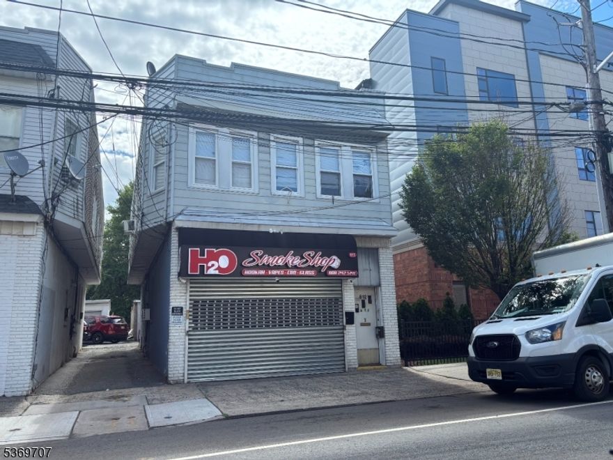 Excellent investment opportunity. Established store (Smoke Shop rent is $2500), established tenant with existing lease. First floor apartment rented @ $1950 per month, second floor is one large unit - rent is $2525. The rents are apparently lower than market value. The garage is being rented for $350 month. Total monthly income is $7,325. Tenants pay all utilities except for water, sewer insurance and maintenance. Building is in very nice condition over all. There is an unfinished basement.  Updated windows. Very large deep lot 200 feet.