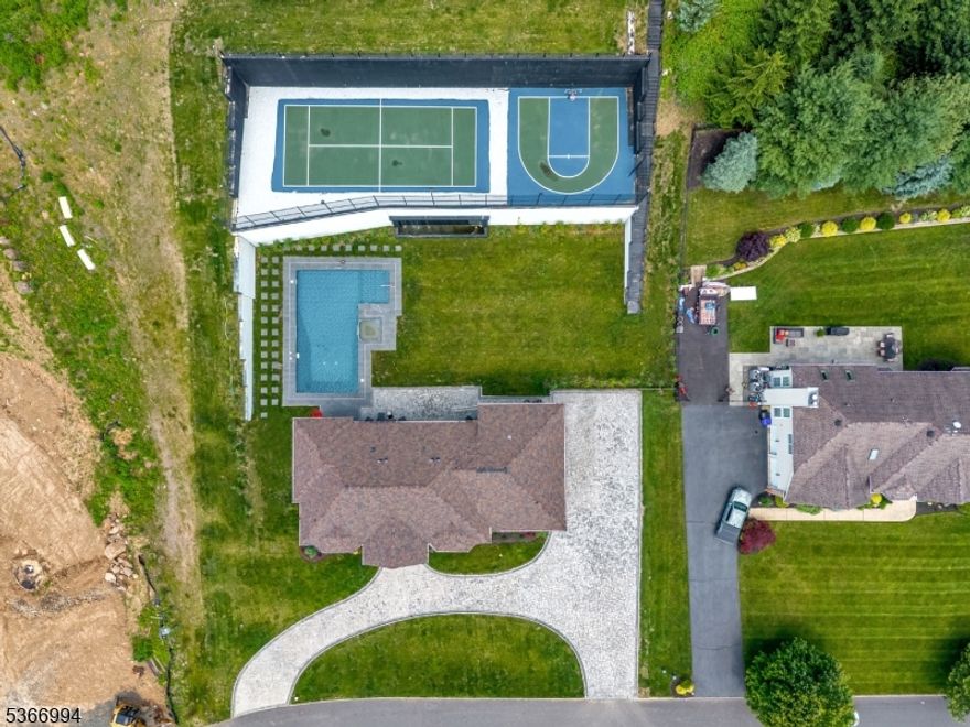 An exceptional brand-new custom estate offering 6,000+ square feet of refined luxury across all levels. Absolutely beautiful interior and exterior spaces, perfectly positioned on an expansive tiered property, this residence delivers breathtaking panoramic views and a true resort-style lifestyle. The private backyard is a showpiece, featuring an in-ground pool and spa, waterfall, patio, and a full sports court designed for both basketball and pickleball/tennis. Every detail of the home has been thoughtfully curated to balance sophisticated design with everyday comfort, highlighted by a dramatic floating staircase, custom millwork, designer lighting, and multiple balconies capturing sweeping views. An open-concept layout creates seamless flow throughout the main living spaces, anchored by a stunning chef?s kitchen with premium finishes and effortless connection to elegant living and dining areas. The upper level features a magnificent primary suite complete with two oversized walk-in closets, private balcony access, and a spa-like bath with soaking tub, double vanity, and glass-enclosed shower. The fully finished lower level offers exceptional bonus living space with a media area, wet bar, expansive rec area, and full bath. Additional highlights include a 3 car garage and smart home technology. A rare opportunity to own a truly one-of-a-kind new construction home in Totowa, combining striking architecture, luxury amenities, and an unparalleled setting.